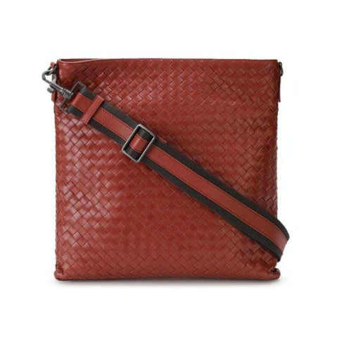 Red woven handbag with a strap on a white background