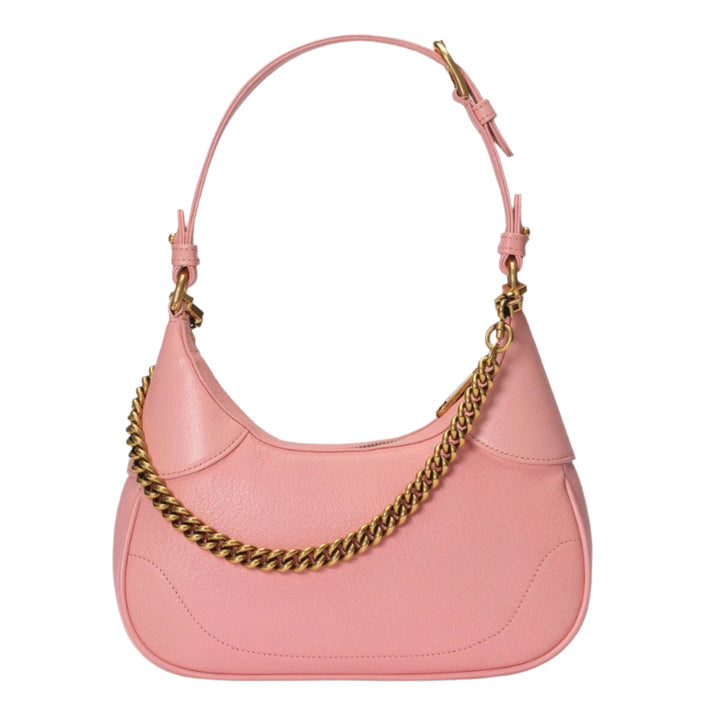 Pink handbag with gold chain detail on a light purple background