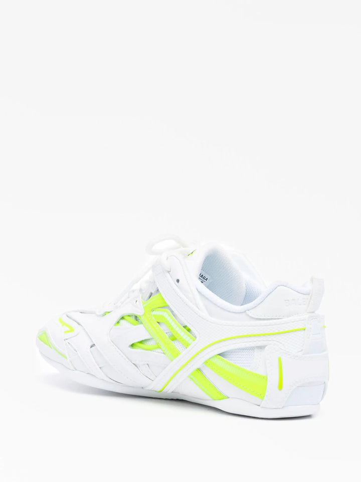 White athletic shoe with neon green accents on a white background