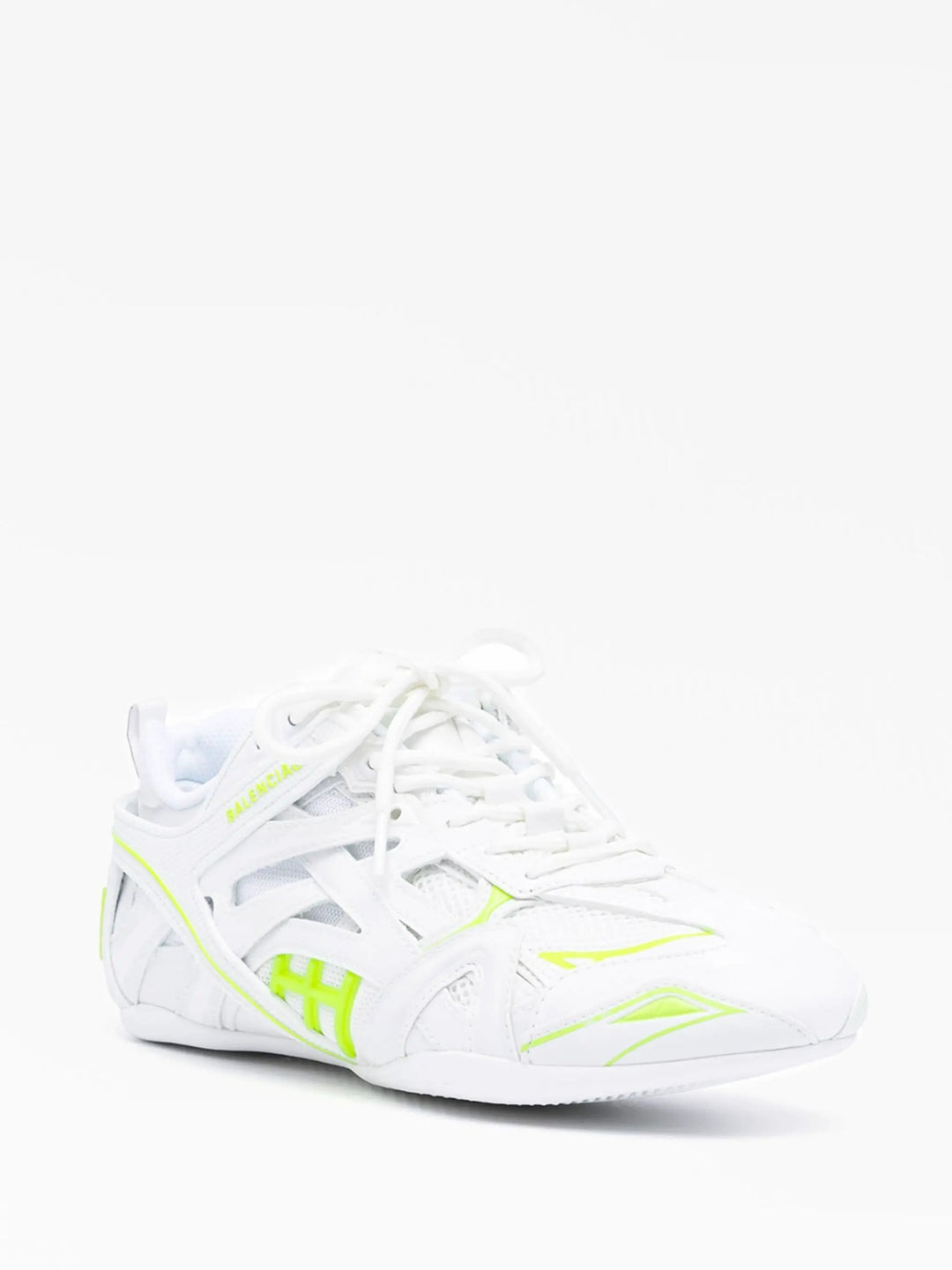 White sneaker with neon yellow accents on a white background