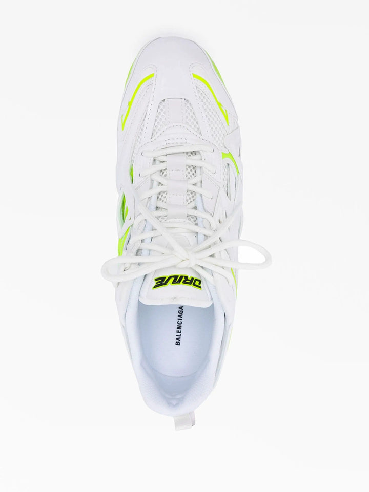 White sneaker with neon green accents on a white background