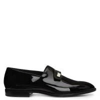 Black patent leather loafer on a white background