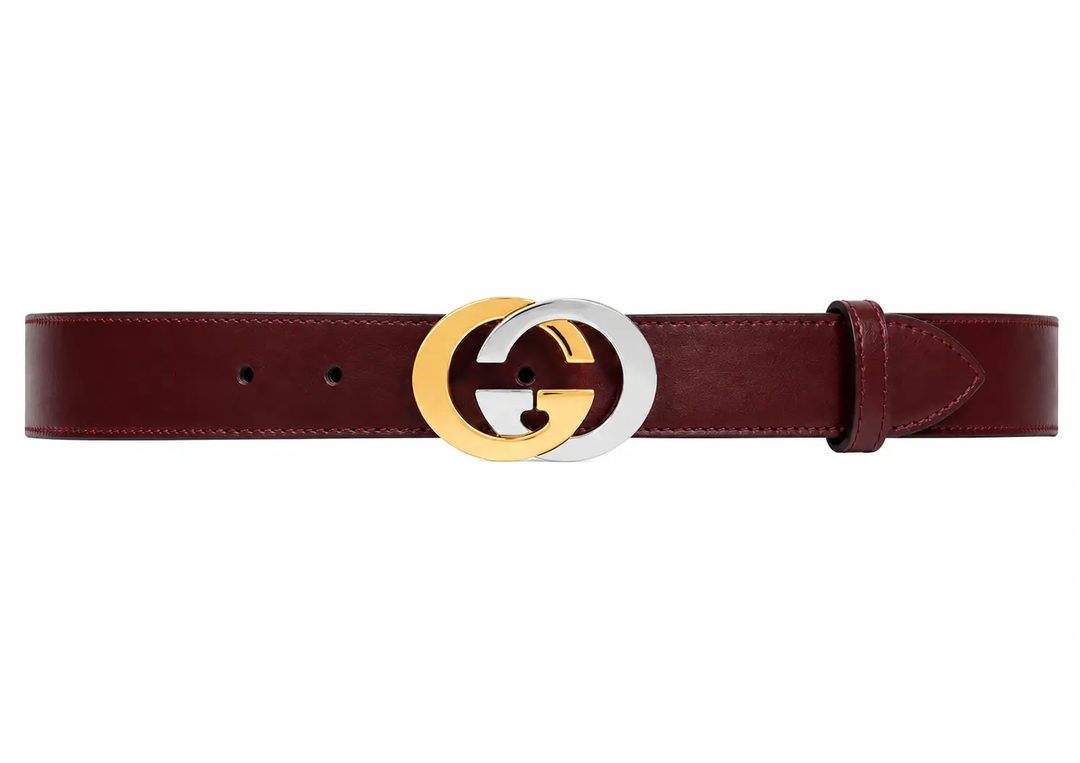 Brown belt with a gold and silver G buckle on a white background