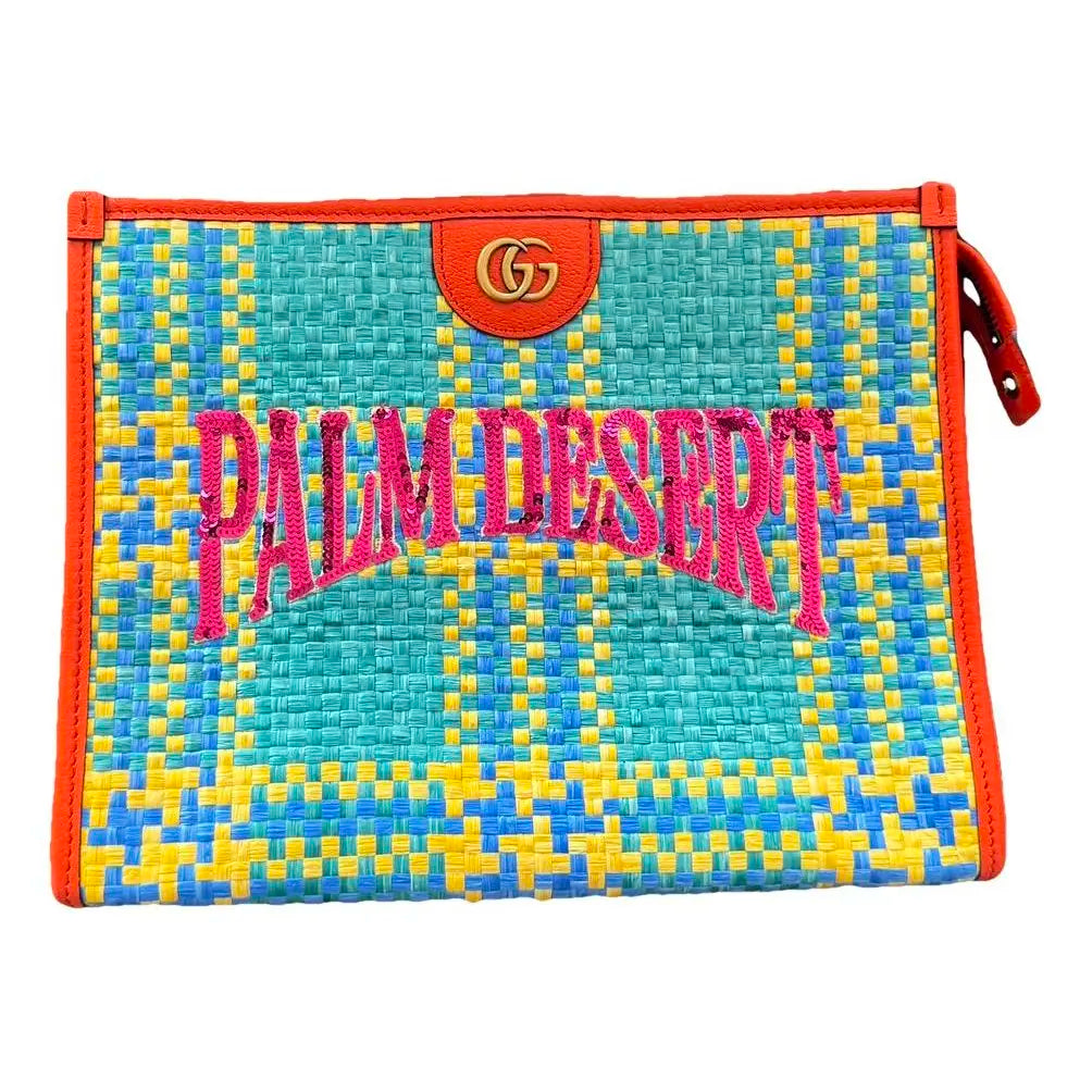 Woven pouch with 'Palm Desert' text and Gucci logo on a white background