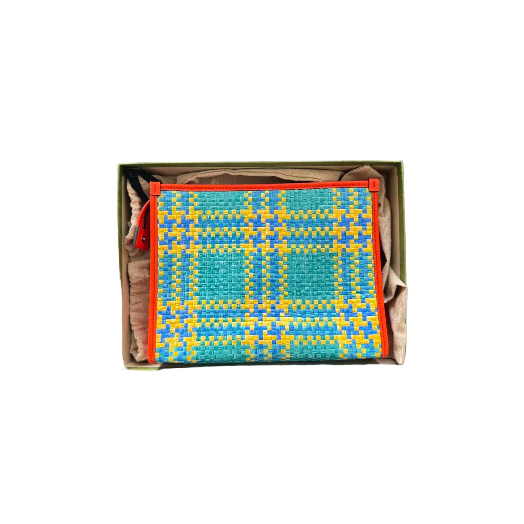 Colorful woven mat in a box on a tiled floor