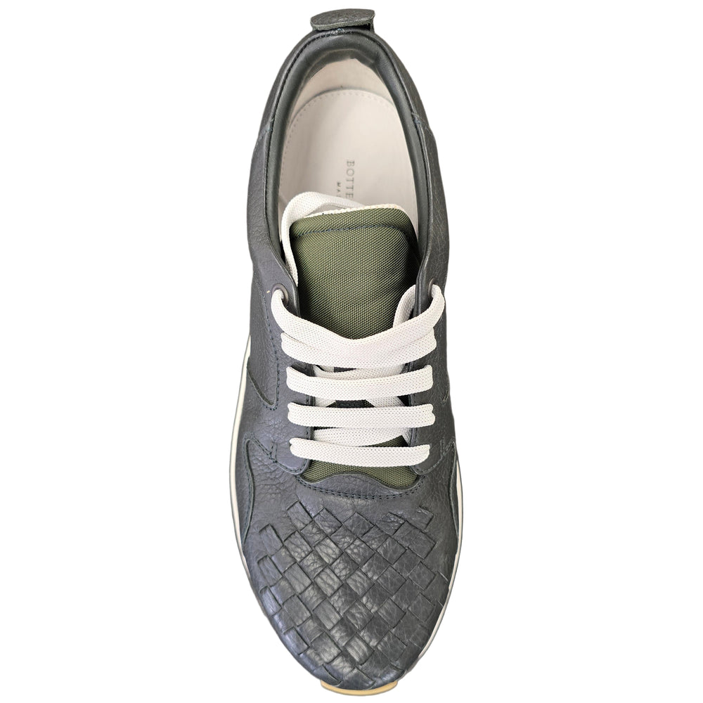 Gray sneaker with white laces on a gray background
