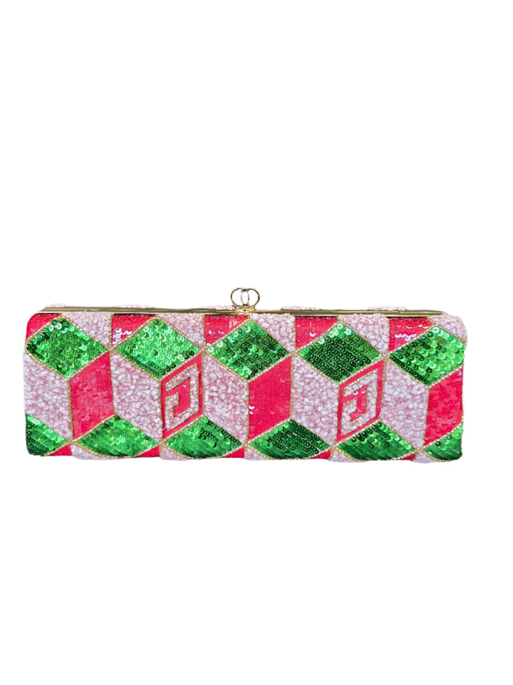 Decorative clutch with green and pink geometric pattern on a gray surface