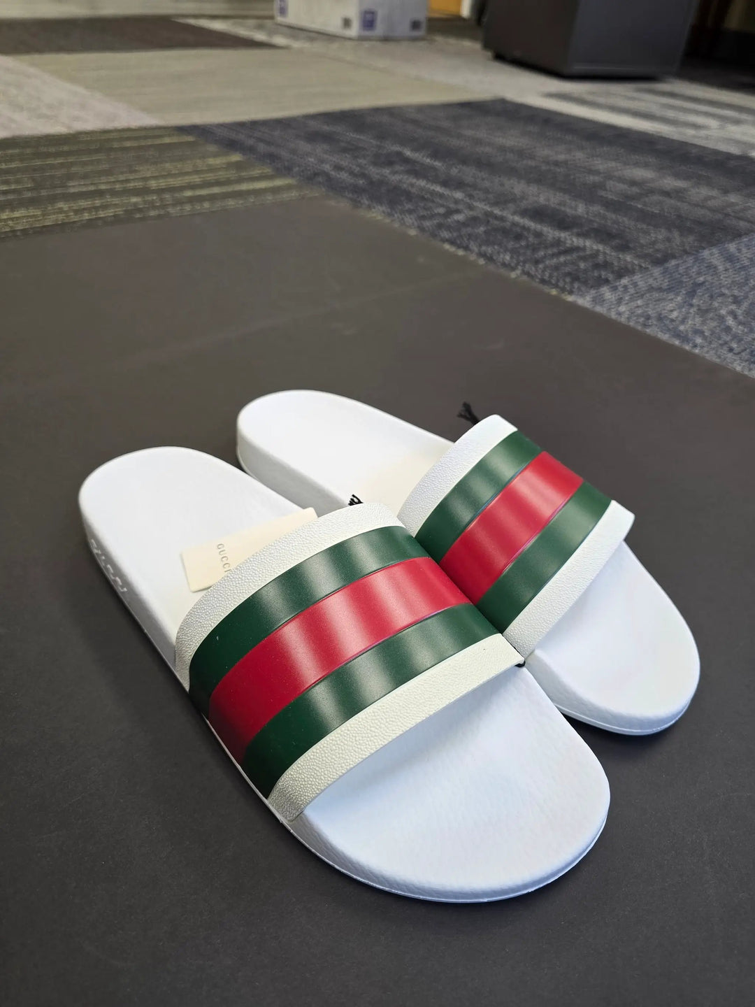 White slides with red and green stripes on a dark surface