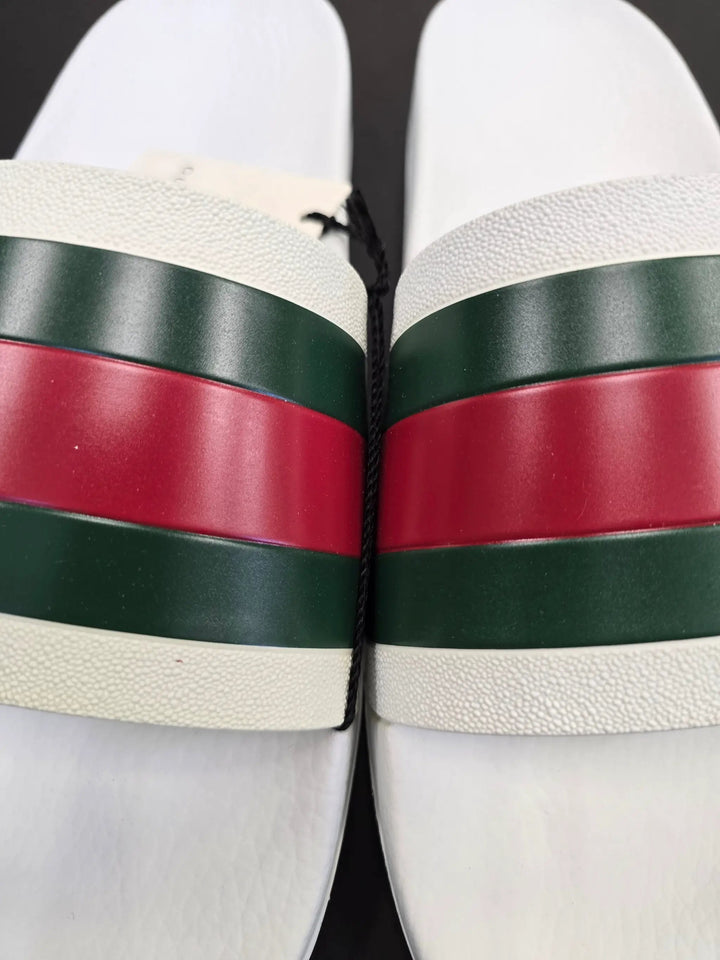 Close-up of a sports ball with green and red bands on a white background